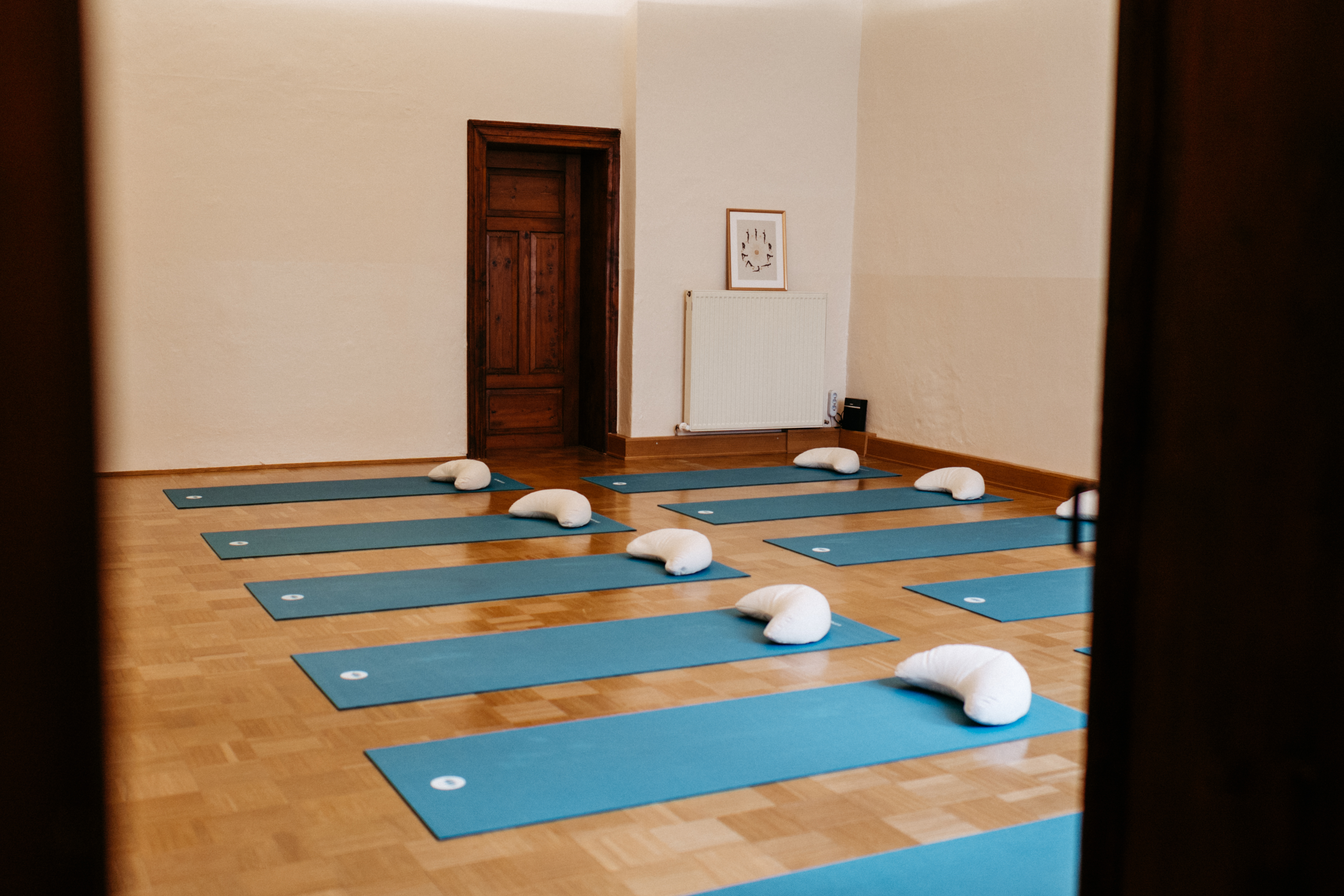 Yoga: Harmonische Wohlfühlatmosphäre: Der Kursraum im Studio „Hier & Jetzt“ ist mit blauen Matten, Kissen, Klangschalen und einem großen Gong für die nächste Yoga-Stunde vorbereitet. - Hier & Jetzt – Yogastudio für Körper, Geist & Seele in Straubing